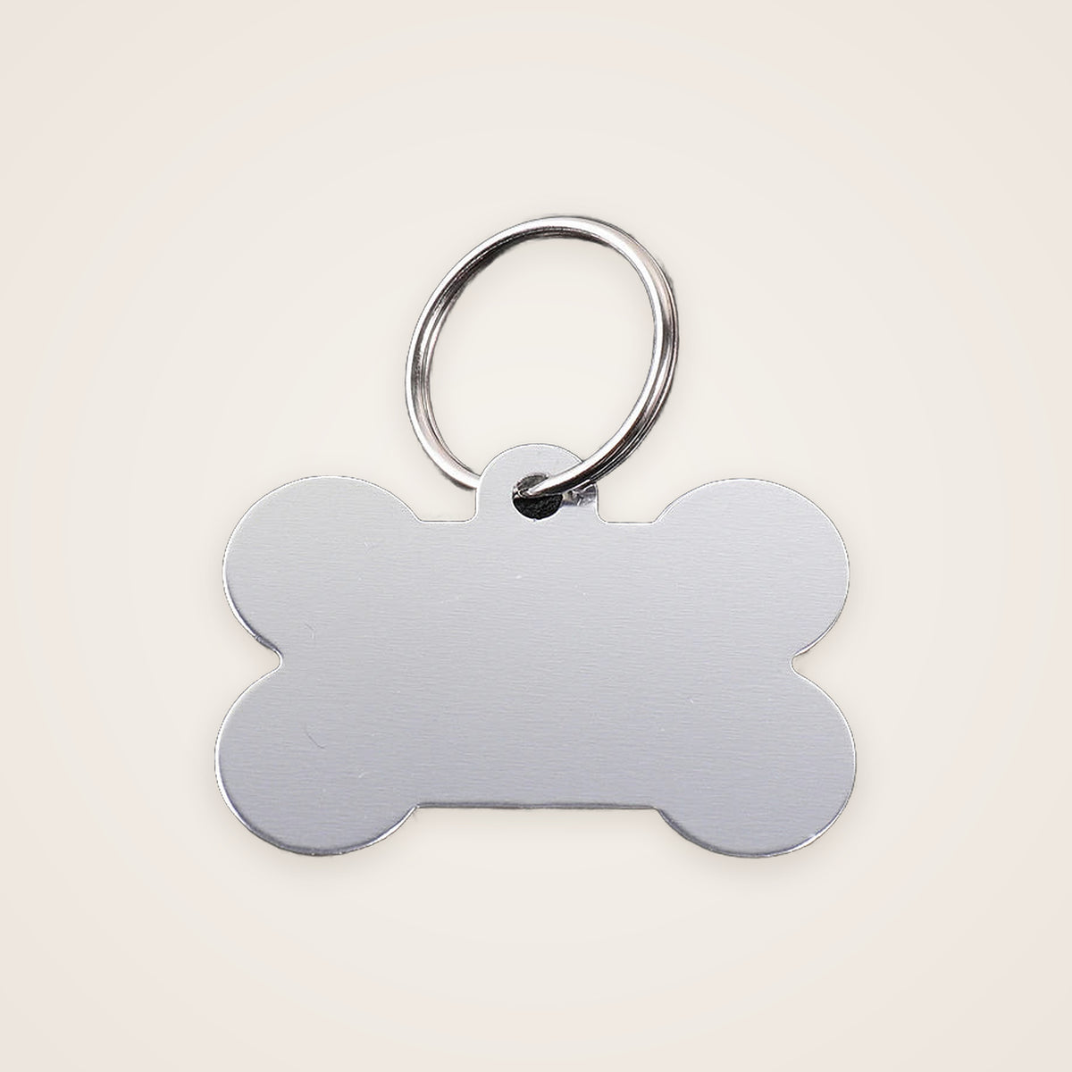 Silver bone-shaped engraved dog ID tag
